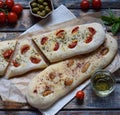 Traditional Italian Focaccia with tomatoes, basil, garlic and sumach. Homemade pastry. Flat bread. Organic flatbread. Rustic style Royalty Free Stock Photo