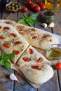 Traditional Italian Focaccia with tomatoes, basil, garlic and sumach. Homemade pastry. Flat bread. Organic flatbread. Rustic style Royalty Free Stock Photo