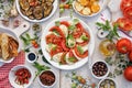 Traditional Italian food, caprese salad made of sliced fresh tomatoes, mozzarella cheese and basil  served on a white plate Royalty Free Stock Photo