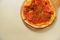 Traditional italian food. Delicious fresh pizza with bolognese sauce, tomatoes, pepper on wooden board, flat lay. Royalty Free Stock Photo