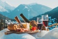 Traditional Italian food and drink in sunny winter day. Romantic alpine picnic in Dolomites with mountains background Royalty Free Stock Photo