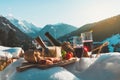 Traditional Italian food and drink in sunny winter day. Romantic alpine picnic in Dolomites with mountains background Royalty Free Stock Photo