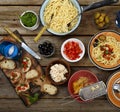 Traditional Italian food. Pasta spaghetti with tomato sauce, olives and garnish with wine on the wooden table Royalty Free Stock Photo