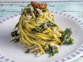 Linguine pasta with fresh anchovies, black cabbage and dried tomato Royalty Free Stock Photo