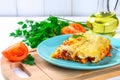 Traditional Italian pasta cannelloni. Baked tubes stuffed with minced meat with parmesan cheese and bechamel sauce on a white wood Royalty Free Stock Photo