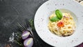 Traditional Italian pasta dish, spaghetti carbonara with yolk, parmesan cheese on a plate. Royalty Free Stock Photo