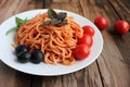 Traditional Italian pasta and ingredients on the white plate on rustic wooden table background. Long spaghetti with tomato sauce, Royalty Free Stock Photo