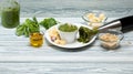 Traditional Italian pesto sauce made from fresh Basil leaves with pine nuts, Parmesan cheese and olive oil using a blender. Wooden Royalty Free Stock Photo