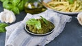 Traditional italian pesto sauce in a plate on a black table. For fusilini pasta. Vegetarian food, for health and good Royalty Free Stock Photo