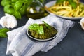 Traditional italian pesto sauce in a plate on a black table. For fusilini pasta. Vegetarian food, for health and good Royalty Free Stock Photo