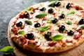 Traditional Italian pizza with black olives Royalty Free Stock Photo