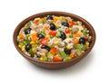 Italian rice salad with tuna in a brown ceramic salad bowl isolated on a white background.