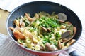 Traditional Italian seafood pasta with fried shrimps and zucchini in a pan Royalty Free Stock Photo