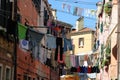 Traditional Italian street with clothes hanging out to dry between old houses, somewhere in Venice.