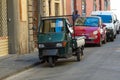 Traditional Italian three wheel car Piaggio Ape staying parked on the street