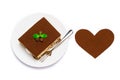 Traditional Italian Tiramisu square dessert portion on ceramic plate and heart shape made of cocoa powder isolated on Royalty Free Stock Photo