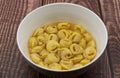 Traditional Italian Tortellini in brodo on wooden table