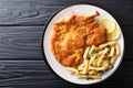 Traditional Italian veal Milanese with lemon and French fries cl