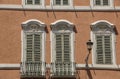 Traditional Italian windows and balconies with shutters in one o