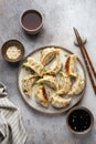 Traditional japaneese gyoza dumplings with meat and mushrooms on ceramic plate