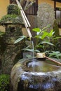 Traditional japanese bamboo purification fountain for purification at entrance of the Japanese temple. Royalty Free Stock Photo