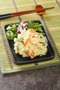 Traditional Japanese creamy potato salad with carrots, eggs and fresh cucumber close-up in a plate. Vertical Royalty Free Stock Photo