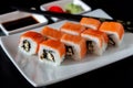 Traditional Japanese cuisine. Philadelphia sushi roll made of fresh salmon, avocado and cream cheese with black rice Royalty Free Stock Photo