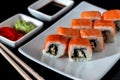 Traditional Japanese cuisine. Philadelphia sushi roll made of fresh salmon, avocado and cream cheese with black rice Royalty Free Stock Photo