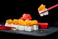 Traditional Japanese cuisine. Process of eating sushi rolls and Royalty Free Stock Photo