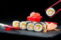 Traditional Japanese cuisine. Process of eating sushi rolls with Royalty Free Stock Photo