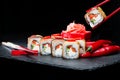 Traditional Japanese cuisine. Process of eating sushi rolls with Royalty Free Stock Photo