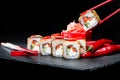 Traditional Japanese cuisine. Process of eating sushi rolls with Royalty Free Stock Photo