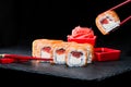 Traditional Japanese cuisine. Process of eating sushi rolls with Royalty Free Stock Photo