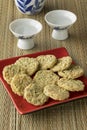 Japanese cups with sake and seaweed rice crackers Royalty Free Stock Photo