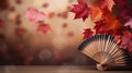 Traditional Japanese fan with red autumn leaves, fall vibes background Royalty Free Stock Photo