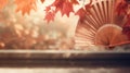 Traditional Japanese fan with red autumn leaves, fall vibes background Royalty Free Stock Photo