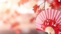 Traditional Japanese fan with red autumn leaves, fall vibes background Royalty Free Stock Photo