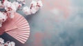 Traditional Japanese fan sensu in pink sakura blossom, spring vibes background