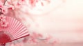 Traditional Japanese fan sensu in pink sakura blossom, spring vibes background