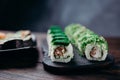 Traditional Japanese sushi rolls on dark plate Royalty Free Stock Photo