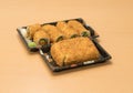 Traditional Japanese food - portion of several kinds of sushi, with sushi toast, cut into four pieces on a trays with wasabi and p