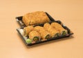 Traditional Japanese food - portion of several kinds of sushi, with sushi toast, cut into four pieces on a trays with wasabi and p