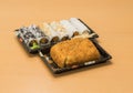 Traditional Japanese food - portion of several kinds of sushi, with sushi toast, cut into four pieces on a trays with wasabi and p