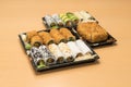 Traditional Japanese food - portion of several kinds of sushi, with sushi toast, cut into four pieces on a trays with wasabi and p