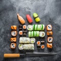 Traditional Japanese food of sushi, rolls and knife on grey background. Flat lay, Top view Royalty Free Stock Photo