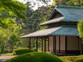 Traditional Japanese house in spring season with the in the middle of the green park with forest and flowers Royalty Free Stock Photo