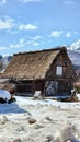 A traditional Japanese house with a thatched roof with snow all around Royalty Free Stock Photo