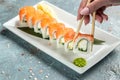 Traditional Japanese kitchen, delicious fresh sushi roll set. Sushi roll with rice, cream chees, red fish, salmon. Sushi menu, Royalty Free Stock Photo