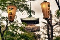 Traditional Japanese lanterns with the temple in the background in a shallow focus Royalty Free Stock Photo