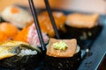 traditional japanese local food sushi.delicious seafood sushi with wasabi and seaweed on black plate.japanese chef cook sushi for Royalty Free Stock Photo